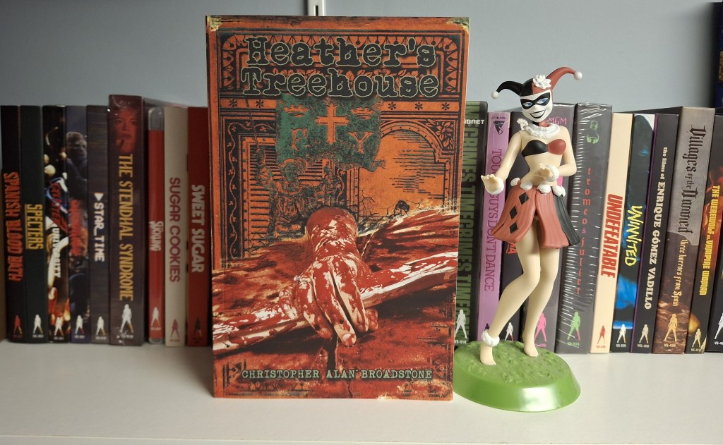 Hula Harley Quinn showcases the novel "Heather's Treehouse" against a backdrop of Vinegar Syndrome Blu-rays.