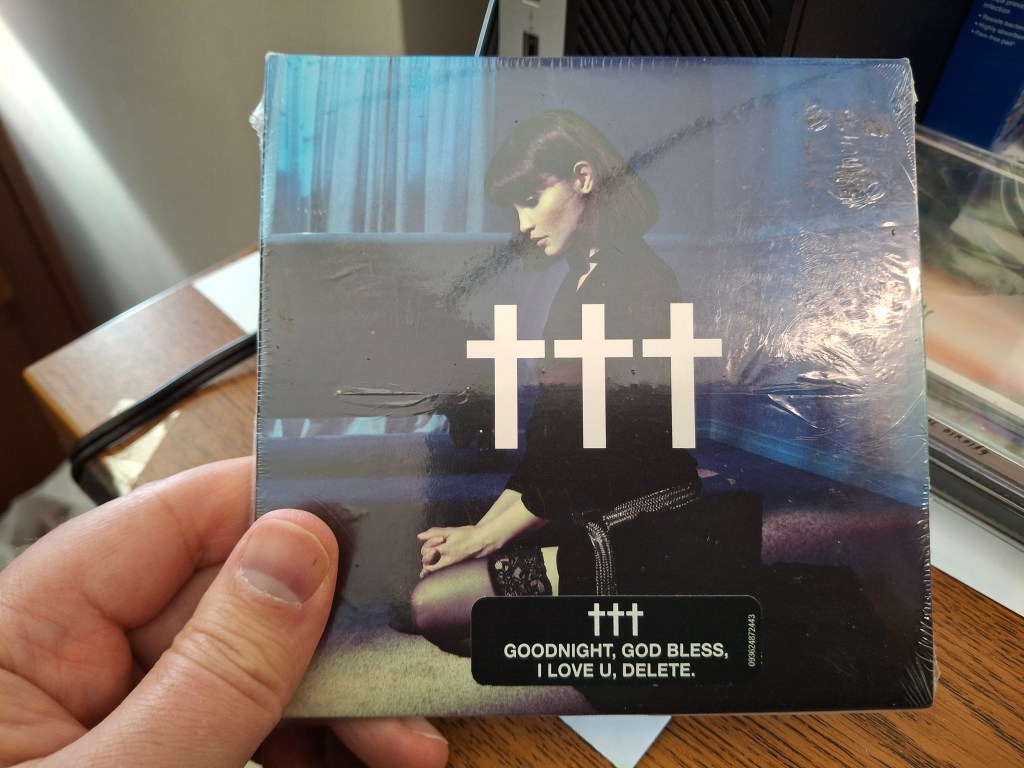 The author holds a (Crosses) CD in his hand.